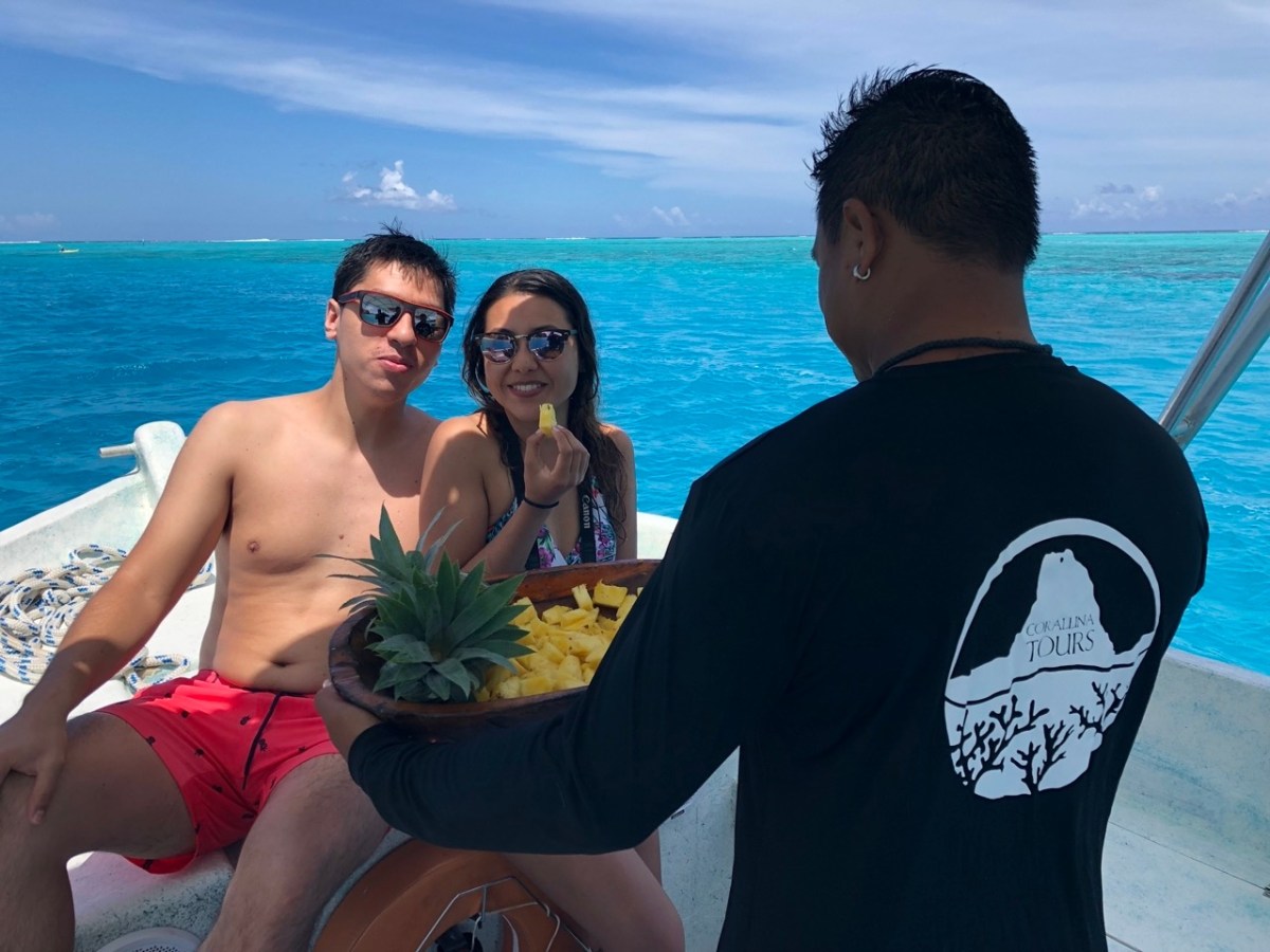a couple of people that are standing in front of a body of water
