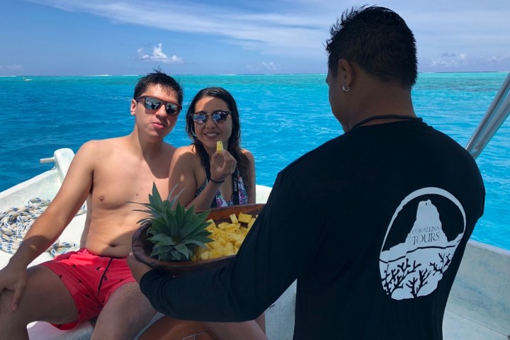 a couple of people that are standing in front of a body of water